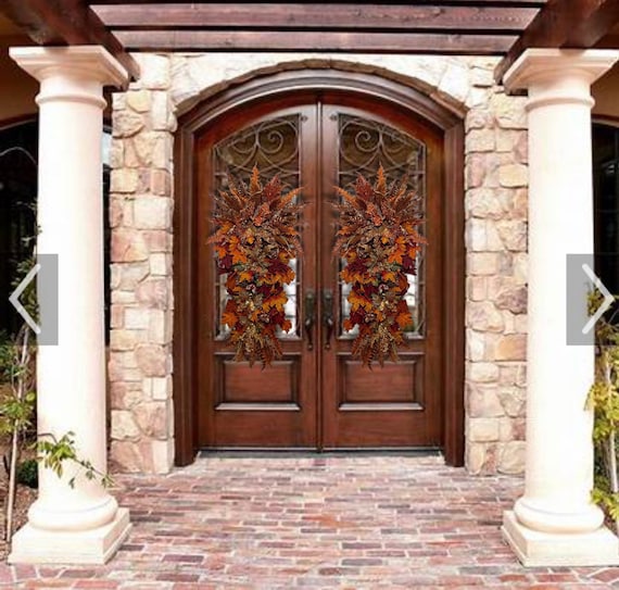 Double door Fall thanksgiving elegant poinsettia pomegranate chocolate brown rust copper front door teardrop wreath swag