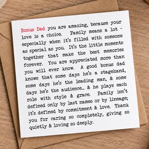 May include: A square white greeting card featuring black typewriter-style text and the red words Bonus Dad. The message reads: Bonus Dad you are amazing, because your love is a choice. Family means a lot - especially when it's filled with someone as special as you.