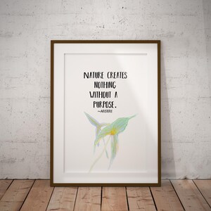 May include: Framed print with the quote "NATURE CREATES NOTHING WITHOUT A PURPOSE." in black text. A watercolor illustration of a green and yellow flower is below the text. The frame is brown, and the background is white.
