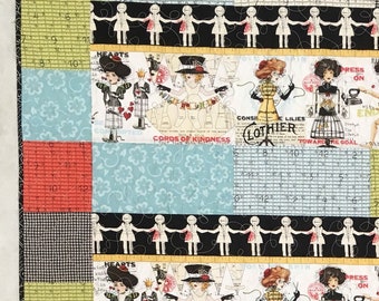 Sewing girl print quilt in black and bright colors