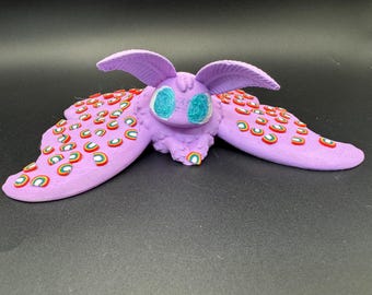 Lilac Purple Laying Moth Figure With Rainbows