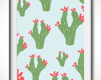 Puede incluir: Una impresión enmarcada con un patrón repetido de cactus verdes con flores rojas sobre un fondo azul claro.
