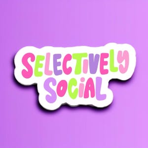 May include: A white sticker with the words "SELECTIVELY SOCIAL" in colorful bubble letters. The text is in shades of pink, green, and purple, with a white outline. The background is a solid purple color.