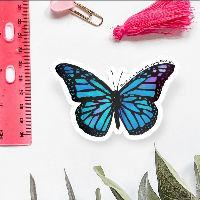 May include: A blue and purple butterfly sticker with the text "there is a time for everything." The sticker is on a white background.