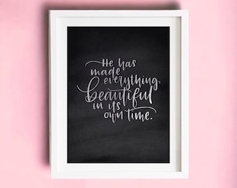 May include: A framed print with a black background and white text that reads "He has made everything beautiful in its own time."
