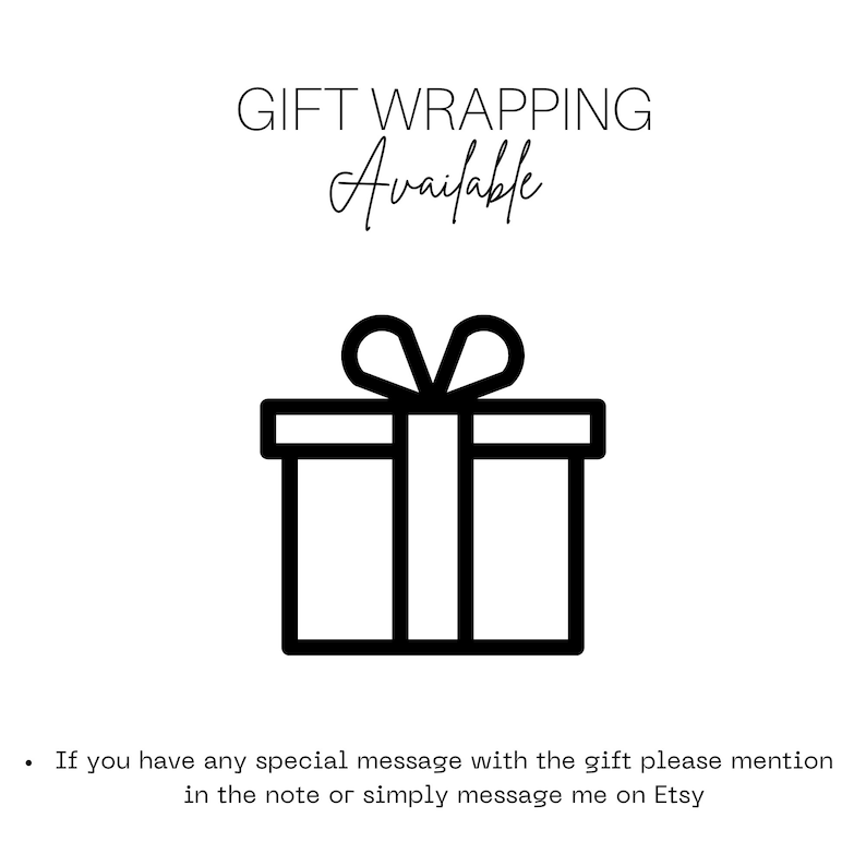 May include: A black and white graphic with the words "GIFT WRAPPING Available" above a simple line drawing of a gift box with a bow. The image is on a white background.