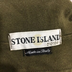 May include: A white label with the text "STONE ISLAND" and a compass logo. The label also has the text "215189" and "Made in Italy" in black.