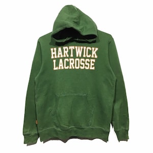 May include: Green hooded sweatshirt with the text "HARTWICK LACROSSE" in white with gold outlining.