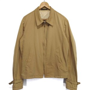 May include: A tan zip-up jacket with long sleeves and a collared neckline. The jacket has a zipper closure and two pockets on the front. The sleeves have adjustable straps at the cuffs.