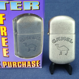 NIB CAMEL LIGHTER Vintage 1997 Flip-top, brushed metal, Refillable. Mint, New/Old Stock in original retail box with catalog & instructions.