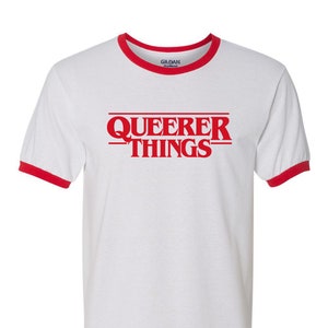 May include: White t-shirt with a red ringer and the text "Queerer Things" in red.