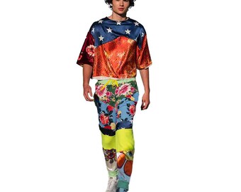 May include: A person wearing a red, white, and blue patterned shirt with a floral print pants. The shirt has a star pattern and the pants have a colorful floral design.