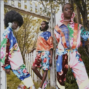 May include: Three people wearing colourful patchwork clothing with floral and geometric patterns. The clothing is made of different fabrics and textures, creating a unique and eclectic style.