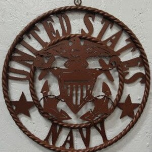 May include: A brown metal wall decor featuring the United States Navy seal with a rope border and five stars. The seal includes an eagle, anchor, and the words "United States Navy".
