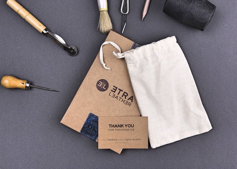 May include: A brown cardboard box with the text "Etra Leather" and a white drawstring bag. The box also has a thank you card that reads "Thank you for choosing us".