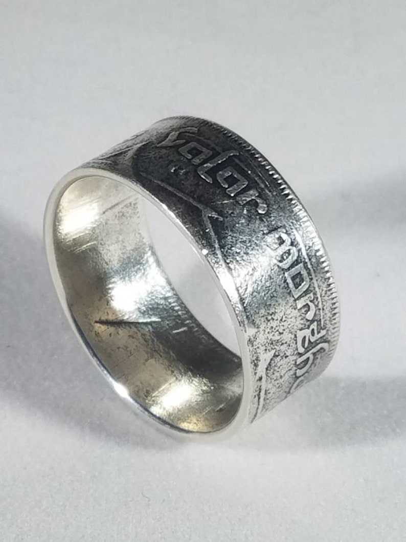 K&ouml;nnte beinhalten: Silberring aus einer wiederverwendeten M&uuml;nze. Der Ring tr&auml;gt die Inschrift "GOD SAVE THE QUEEN" und das Jahr "1967".