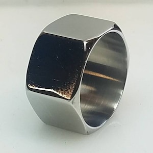 May include: A silver hexagonal ring with a polished finish.