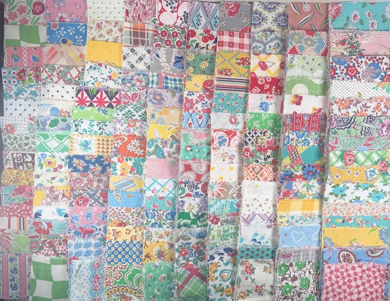 May include: A collection of colorful fabric squares arranged in a grid pattern. The squares feature a variety of floral, geometric, and patterned designs in shades of pink, blue, green, yellow, and red. The fabrics appear to be vintage or retro in style.