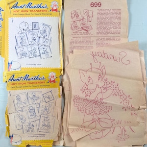 May include: Vintage Aunt Martha's hot iron transfer packets. The yellow packets feature cartoon designs for embroidery, including ducks and kittens. The image also shows a pixie tea towel pattern and other designs.