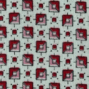 May include: A woven fabric featuring a repeating geometric pattern of red and pink squares on a light gray background. The design consists of larger squares with a split color effect and smaller solid red squares, all outlined in black thread.