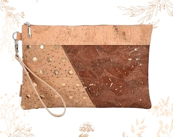 May include: A cork clutch bag with a brown and beige cork design. The bag has a gold star pattern and a brown cork strap. The bag is made in Portugal.