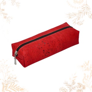 May include: A red cork pencil case with a black zipper.