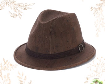 May include: A brown cork fedora hat with a brown leather band and a silver buckle. The hat is made in Portugal.