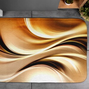 May include: Abstract bath mat with swirling patterns in shades of brown, gold, and white.