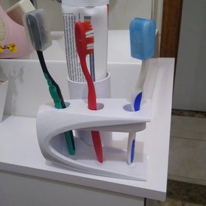 Tooth brush paste holder