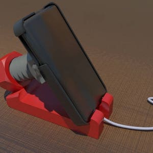May include: A red phone stand with a black phone in a vertical position. The phone is connected to a white charging cable.