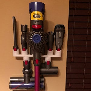 May include: A white wall-mounted storage rack for a Dyson vacuum cleaner and its attachments. The rack has five slots for holding the vacuum cleaner, a crevice tool, a dusting brush, a combination tool, and a mini-motorized head. The vacuum cleaner is purple and gray, and the attachments are all gray.