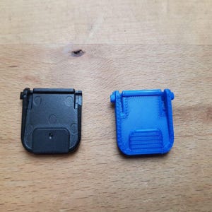 May include: A set of three ceramic mugs with a speckled, matte finish. The mugs are in shades of cream, light gray, and dark gray. Each mug has a simple, minimalist design and a rounded handle.