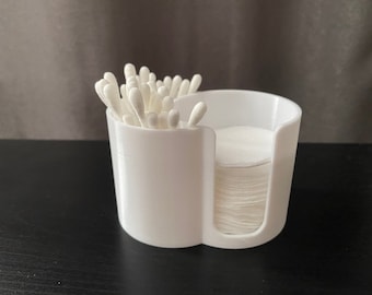 May include: White plastic organizer with two compartments. One compartment holds cotton swabs and the other holds cotton rounds.