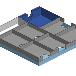 May include: A grey and blue organiser with multiple compartments. The organiser has a large compartment in the top right corner, and four smaller compartments below it. The compartments are lined with a blue material.