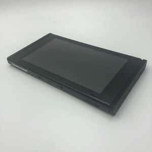 May include: A black Nintendo Switch console with a black screen. The console is closed and lying on its side.