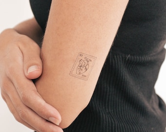 May include: A temporary tattoo of a heart with the word "love" and the number "30" on a postage stamp.
