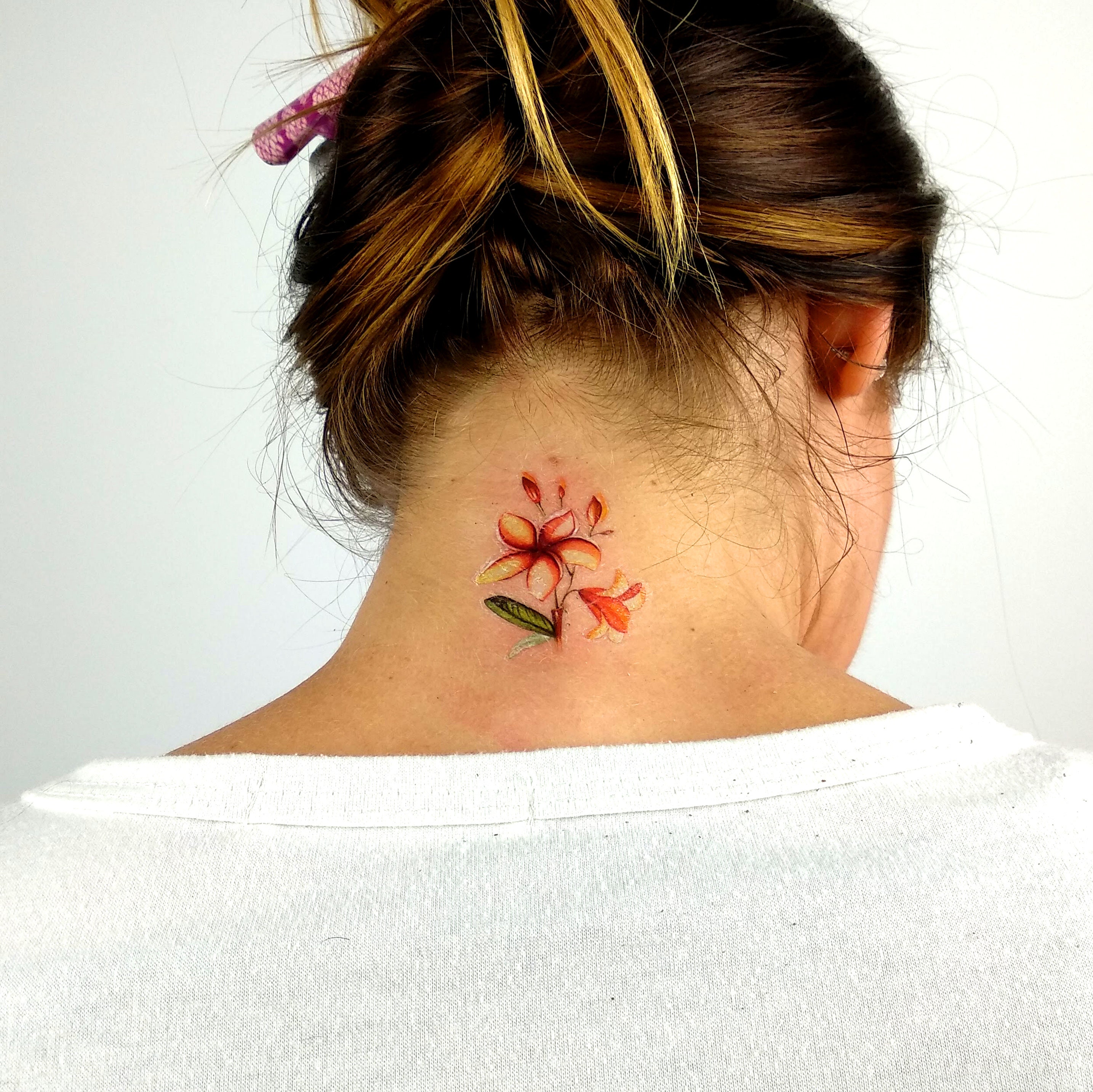 Beautiful colourful plumeria flower on a forearm | Plumeria flower tattoos, Flower  tattoos, Plumeria