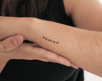 May include: A temporary tattoo with the word "muse" written in cursive.