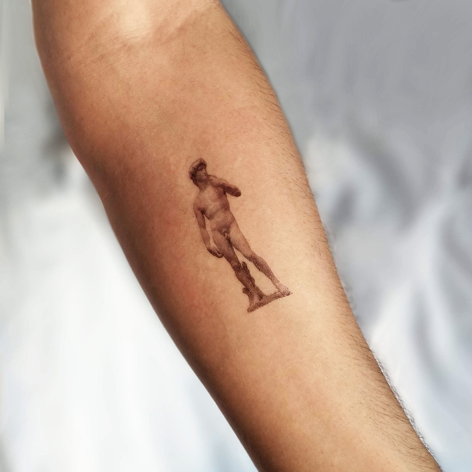 Microrealistic Michelangelos David tattoo done on