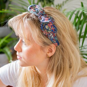 A woman wearing a Liberty London print side bow headband | Holme & Moss