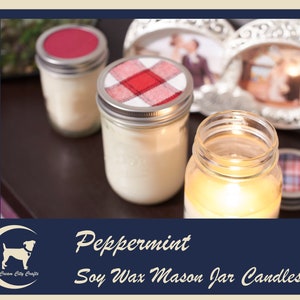 May include: Three glass mason jars filled with white soy wax candles. The candles have different colored lids. One lid is red, one is plaid red and white, and one is a plain silver lid. The jars are sitting on a wooden surface. The text "Peppermint Soy Wax Mason Jar Candles" is written below the jars.