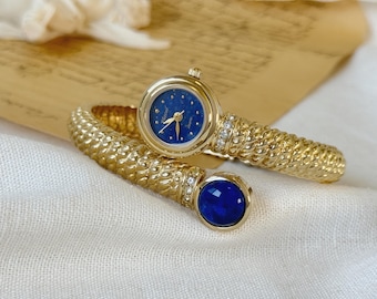 Orologio da donna vintage Vexcel in metallo dorato con pietra blu, orologio con bracciale rigido, orologio gioiello