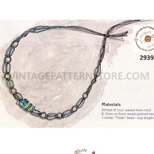 May include: A close-up of a necklace made with brown waxed linen cord and wooden beads. The necklace has a center bead with a blue and green design. The image includes the text "VINTAGE PATTERN STORE ENGLAND 2939 VINTAGEPATTERNTORE.COM".