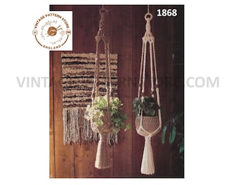 May include: Two macrame plant hangers, one in natural brown and one in white, hanging from a wooden wall. The hangers are made with thick rope and have a tassel at the bottom. The hangers are both holding a potted plant.