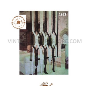 May include: A black and white macrame wall hanging with a geometric pattern. The hanging is made of thick cords and is suspended from a wooden dowel rod. The pattern is created by alternating black and white cords. The hanging is shown in a room setting.