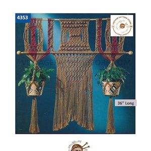 May include: A macrame wall hanging with two plant hangers. The wall hanging is made of brown cord and has a geometric design. The plant hangers are 36 inches long and have a brown and white pot with a plant inside. The wall hanging is labelled "4353" and "Vintage Pattern Store, England".
