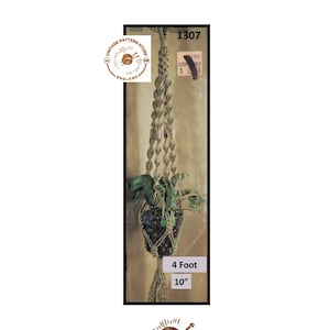 May include: A vintage macrame plant hanger pattern, with a photo of the finished project. The pattern is for a 1.2 metre long hanger, with a 25 cm diameter pot. The pattern is from Vintage Pattern Store, England.