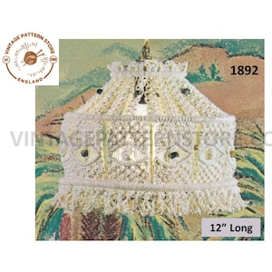 May include: A white crocheted lampshade with a fringe border. The lampshade is 12 inches long and has a geometric design. The image includes the text "Vintage Pattern Store" and "1892".