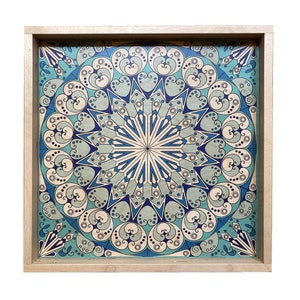 May include: A wooden tray with a blue and white mandala design. The tray is square and has a light wood frame.