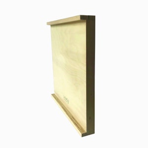May include: A light wood wall shelf with a lip on the bottom edge. The shelf is made of plywood and has a natural wood finish. The text "LYMOU" is printed on the shelf.